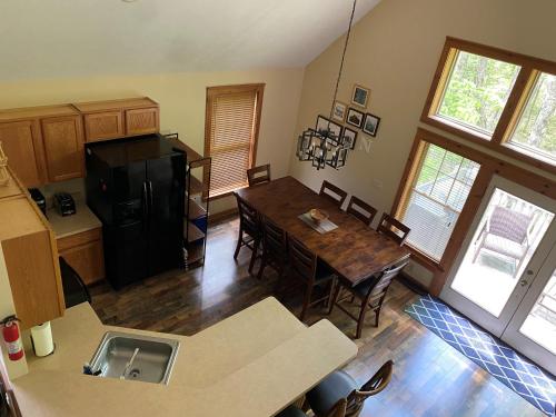 a kitchen and dining room with a table and a refrigerator at Gorgeous House in Camelback Mountain near lifts! in Tannersville