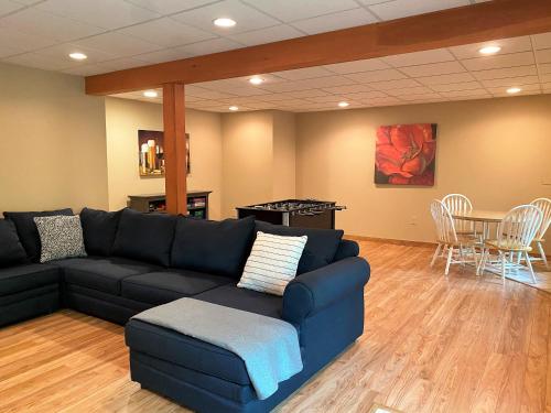 a living room with a blue couch and a table at Gorgeous House in Camelback Mountain near lifts! in Tannersville