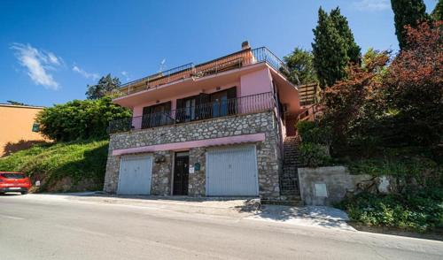 a house with two garage doors on the side of a road at Villa Ray in Capoliveri