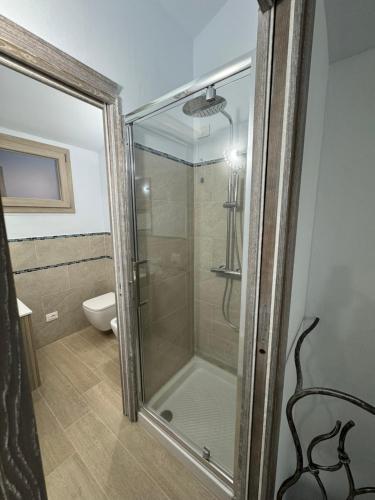 a glass shower in a bathroom with a toilet at Sea View House 5 in Olbia