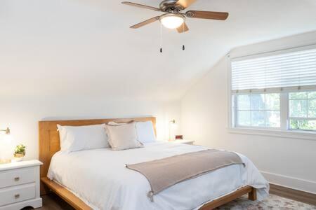 a bedroom with a bed and a ceiling fan at The Corner Cottage Pool Oasis in Penticton