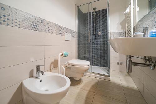 a bathroom with a toilet and a sink at Villa Ray in Capoliveri