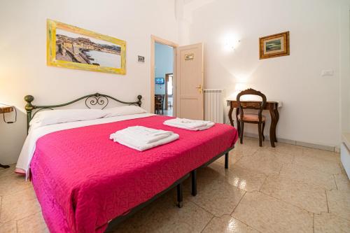 a bedroom with a bed with a red blanket at Villa Ray in Capoliveri