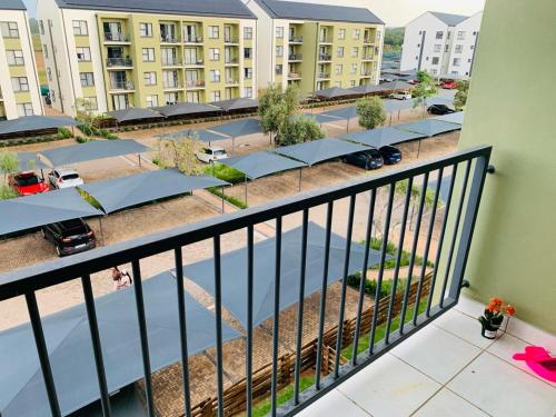 an apartment balcony with a view of a parking lot at Nelly`s Green Creek Luxury Apartment in Pretoria