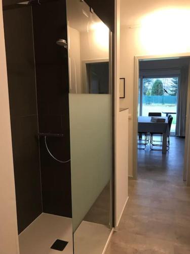 a glass door leading to a room with a table at Chalet am Weiher in Recht