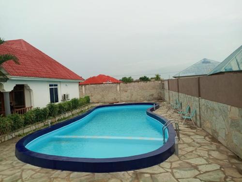 a swimming pool in a yard with a house at Taj hotel partnership in Nungwi