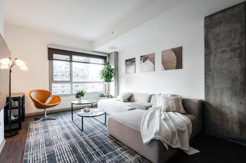 a living room with a couch and a chair at Luxurious Hollywood condo in Los Angeles