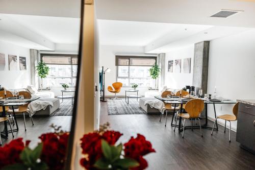 a room with tables and chairs and a living room at Luxurious Hollywood condo in Los Angeles