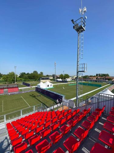 a stadium with red seats and a soccer field at RB Bed & Breakfast in Gaiba