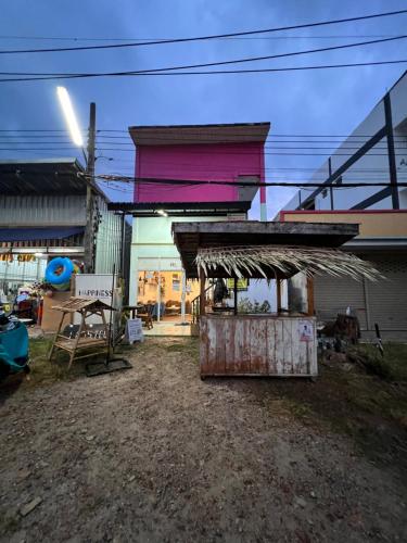 a small building with a roof on top of it at Happiness Hostel in Phra Ae beach