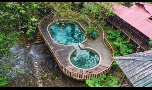 an overhead view of a swimming pool in a wooden deck at cabaña tellin in Termales - agua caliente - nuqui