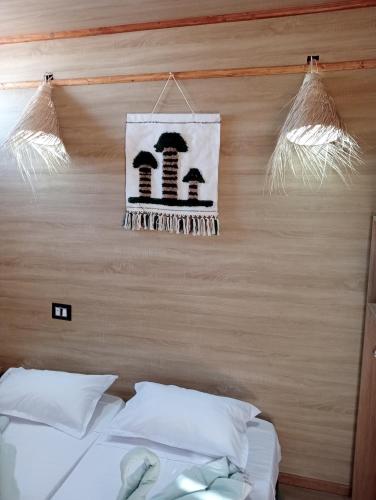 a bedroom with a bed and a sign on the wall at Garden12 Outdoor & More in Douz