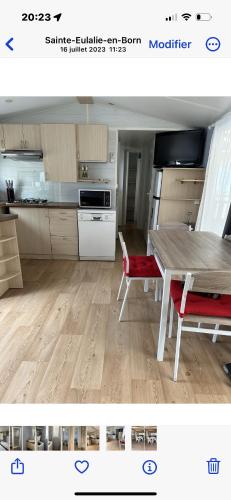 a kitchen with a wooden table and a wooden floor at Camping Lou PK2 emplacement 15 in Sainte-Eulalie-en-Born