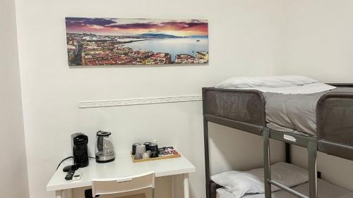 a bedroom with a bunk bed and a desk with a coffee maker at House Caracciolo in Naples