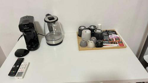 a table with a blender and other items on it at House Caracciolo in Naples