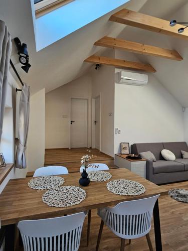 a living room with a wooden table and chairs at Pod vinohradem - apartmány & vinné sklepy in Mutěnice