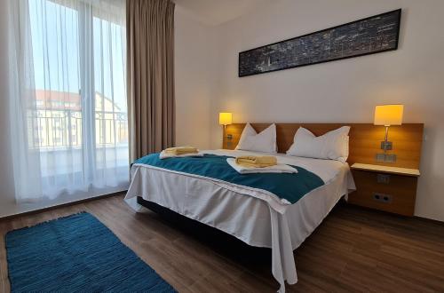 a hotel room with a bed and a large window at Jafar Resort 11 Penthouse in Timişoara