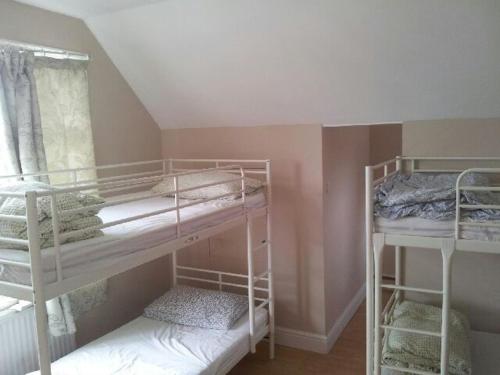 a room with two bunk beds and a window at Compton Guest House in London