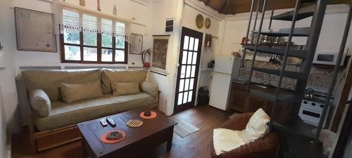 a living room with a couch and a coffee table at Las chozas in Punta del Este