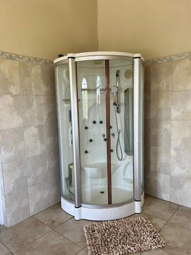 a white shower in a room with a rug at Retreat Guest House in Falmouth
