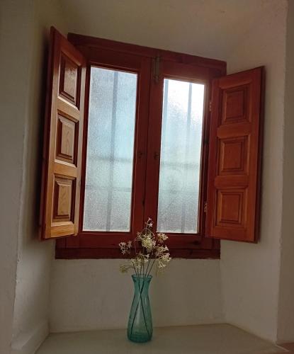 a vase of flowers sitting in front of a window at Casa nuestro sueño in Partaloa