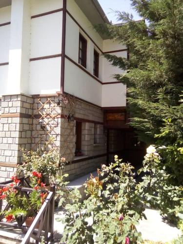 a building with a bunch of flowers in front of it at Αρχοντικό Ειρήνη - 6 Metsovo in Metsovo