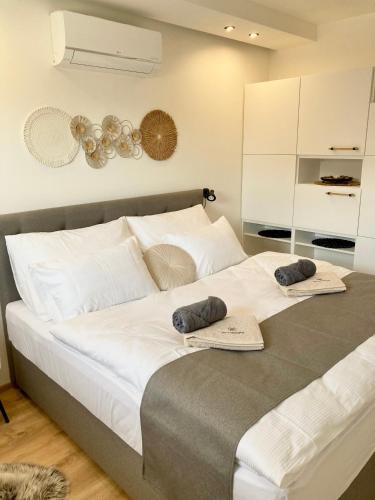 a bedroom with a large bed with two towels on it at Pod vinohradem - apartmány & vinné sklepy in Mutěnice