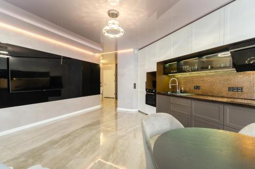 a kitchen with a table and a kitchen with a counter at 13109 Cozy apartment nearby with Kiev Central Railway Station in Kyiv