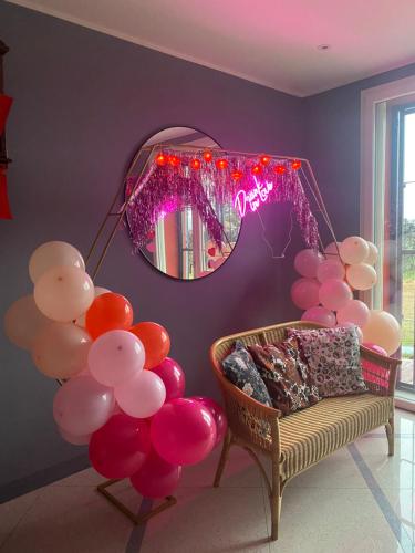 a room with a bunch of balloons and a mirror at Sala dell Estate Guest House in Secchia