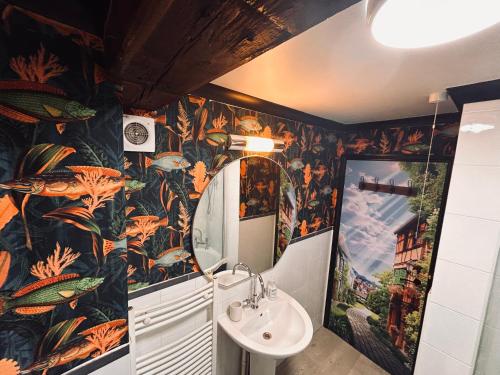 a bathroom with a sink and a colorful wallpaper at Lewes Guest Nest in Lewes