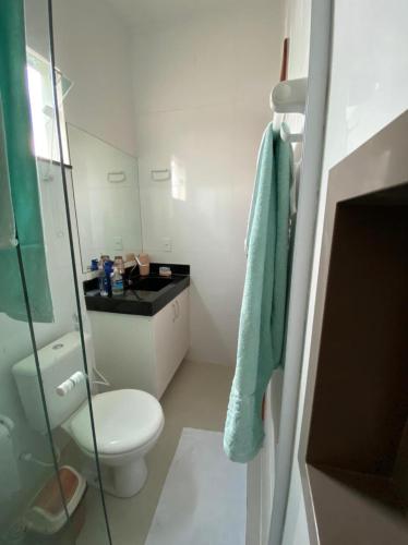 a bathroom with a toilet and a blue towel at Casa do Maro in Santo Amaro