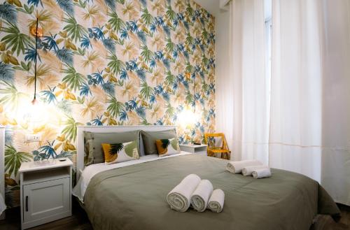 una camera da letto con un grande letto con asciugamani di Casa Cosmedin a Napoli