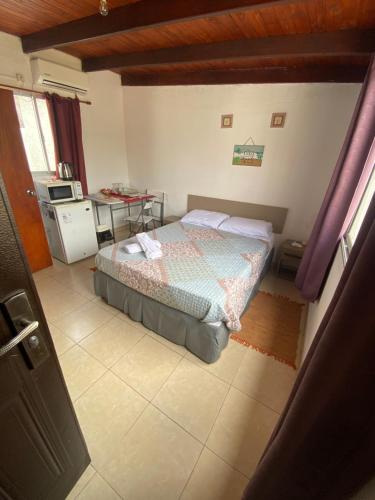 a bedroom with a bed and a table in it at Habitación Juspe in Colonia del Sacramento