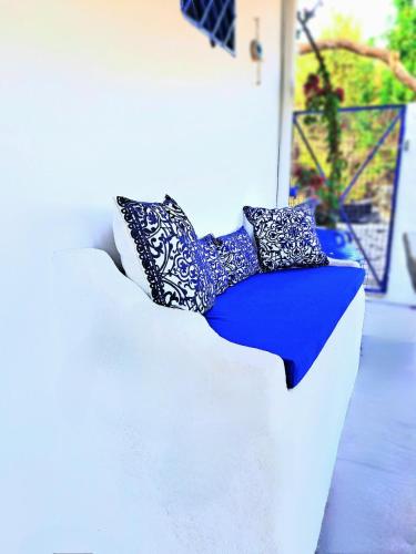 a white couch with pillows on top of it at Aegean Serenity - Sea View Retreat in Archangelos
