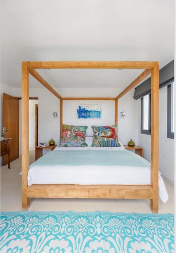 a bed with a wooden frame in a bedroom at Villa Leonor in Es Caló