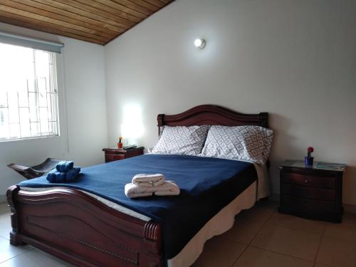 1 dormitorio con 1 cama con 2 toallas en Hostal Norma101, en Bogotá