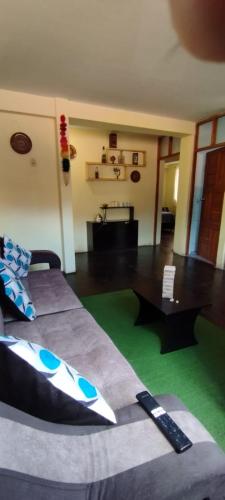 a bedroom with a bed and a green rug at MEDIA LUNA apart in Cusco