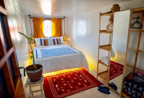 a small bedroom with a bed and a window at Dar Zohra-At the door of Africa. in Tangier