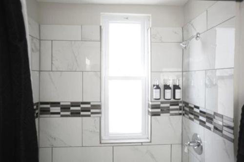 a bathroom with a shower with a window at Cozy Apt Near Midway Airport & Downtown in Chicago