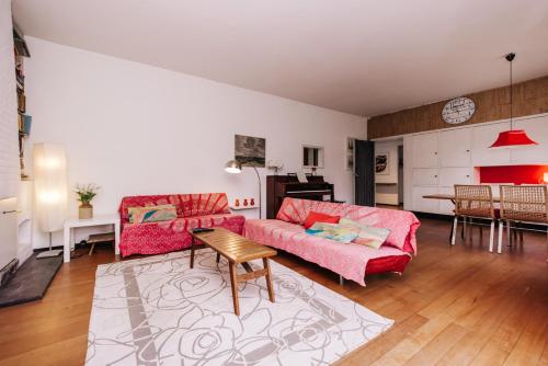 a living room with a couch and a table at Villa Zuidwest 6, Garden, Dunes & Free parking in Zandvoort