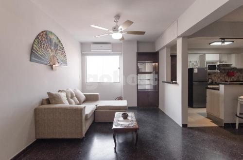 a living room with a couch and a table at Spacious Apartment Located In Downtonwn Asuncin in Asunción