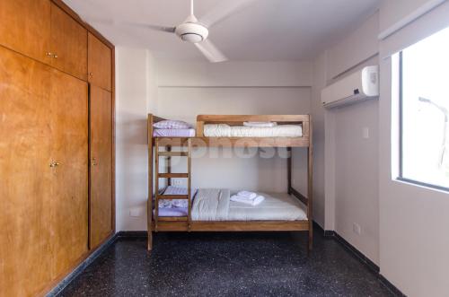 a small room with bunk beds in it at Spacious Apartment Located In Downtonwn Asuncin in Asunción