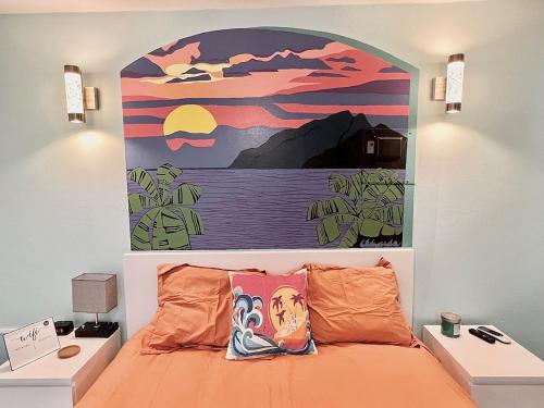 a bedroom with a large painting above a bed at Sunset Room With Folding Wall Access To Pool in Aguada