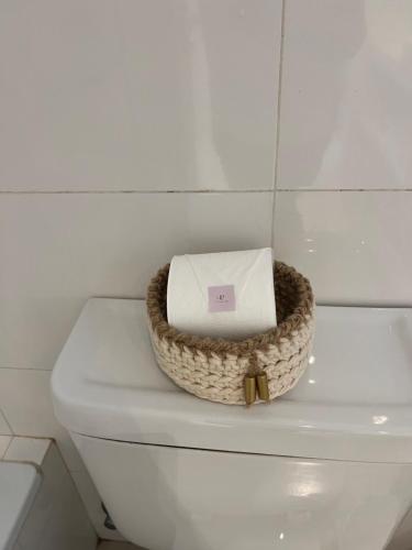 a basket on top of a toilet in a bathroom at Lezama Park in Buenos Aires