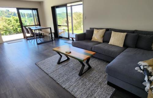 a living room with a couch and a coffee table at Te Tirohanga (The View) in Taumarunui
