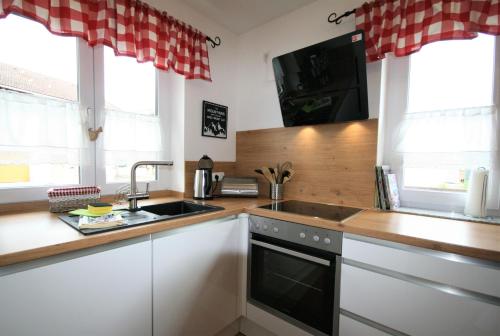 a kitchen with a sink and a stove top oven at Allgäustüble am See in Schwangau