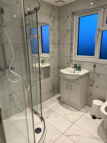 a bathroom with a shower and a sink at Divine touch in Plumstead
