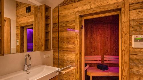 a bathroom with a tub and a sink at Eagles Nest - by Alpen Apartments in Zell am See