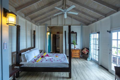 a bedroom with a bed with a ceiling fan at The Ti-Kaye Oasis in Crab Hill