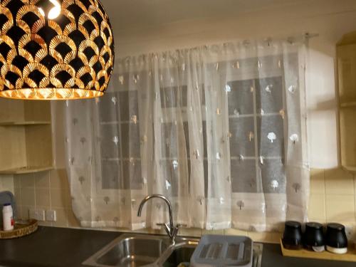 a kitchen with a sink and a window at MAYE HOUSE 